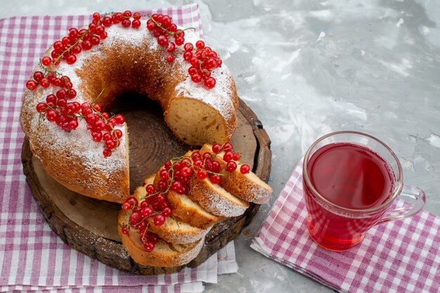 A front view delicious round cake with fresh red cranberries and cranberry juice on the white desk cake biscuit tea berry