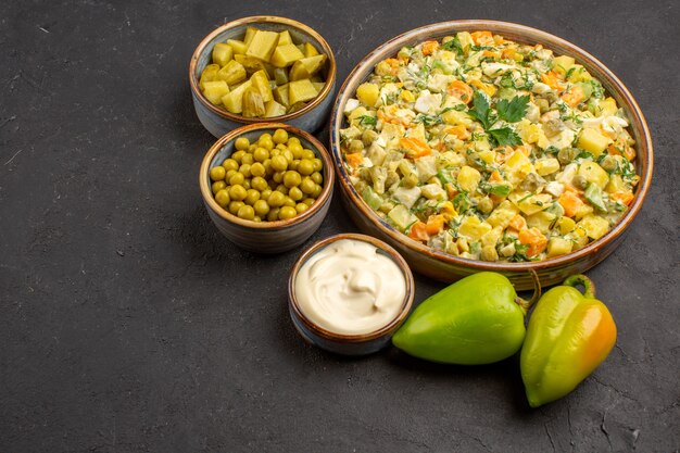 Front view of delicious salad with ingredients on dark surface