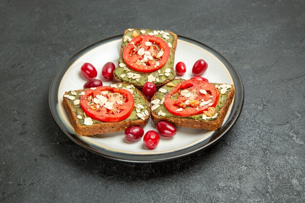 Front view delicious sandwiches with avocado pasta and tomatoes inside plate on grey background burger sandwich bun snack bread