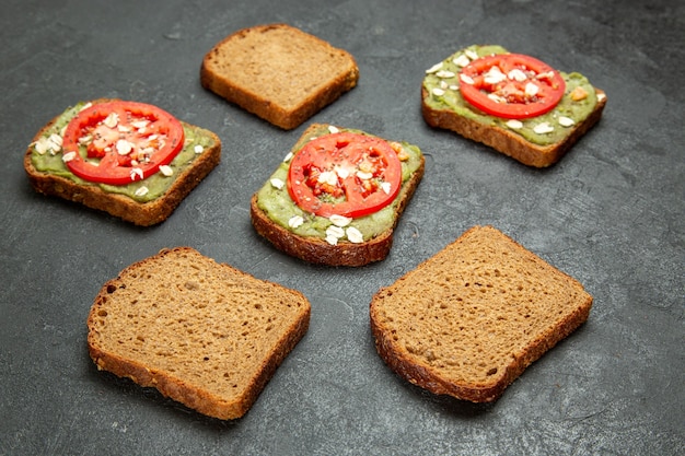 Front view delicious sandwiches with wassabi and red tomatoes on grey background snack meal burger sandwich bread