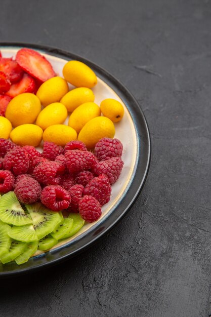 Front view delicious sliced fruits inside plate on a dark surface fruit tree exotic ripe photo tropical