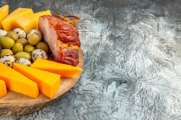 Front view of delicious snack including fruits and foods on a brown tray on ice background