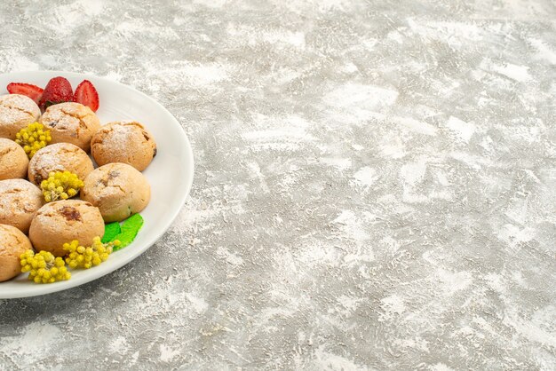 Front view delicious sugar cookies inside plate on a white background sugar cookie sweet biscuit cake tea