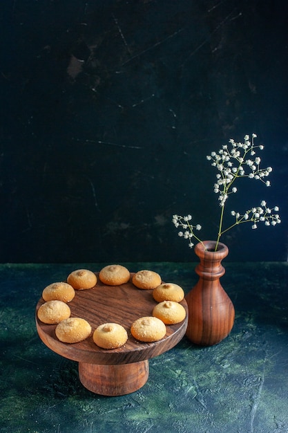 Front view delicious sweet biscuits on dark blue cookie sugar cake pie tea photo dessert