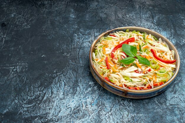 Front view delicious vegetable salad inside tray on grey table