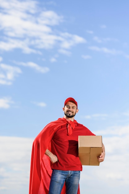 Front view delivery man wearing superhero cape