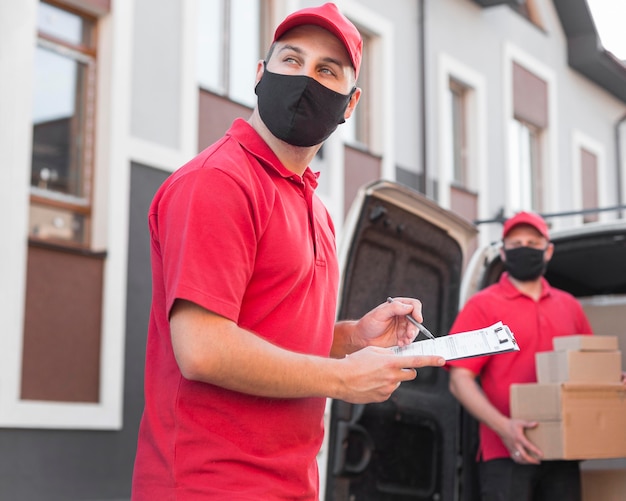 Front view of delivery men with mask