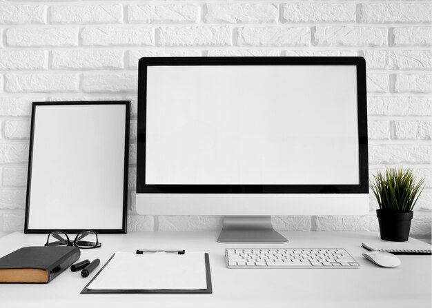 Front view of desk with computer screen and clipboard