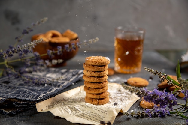 A front view desk with cookies and with tea on the grey table cookie tea biscuit sweet sugar