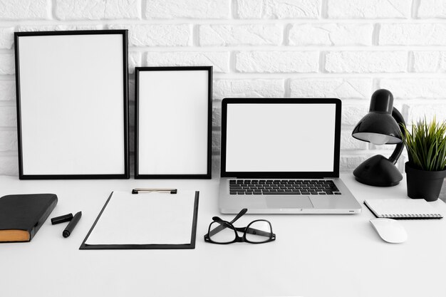 Front view of desk with laptop and glasses