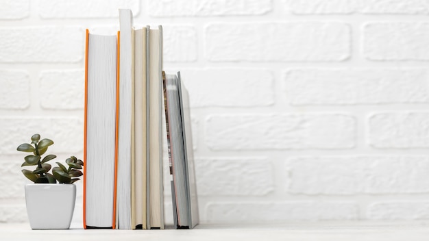 Front view of desk with stacked books and copy space