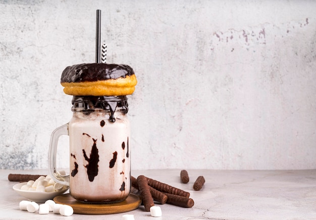 Front view of dessert in jar with donuts and marshmallows