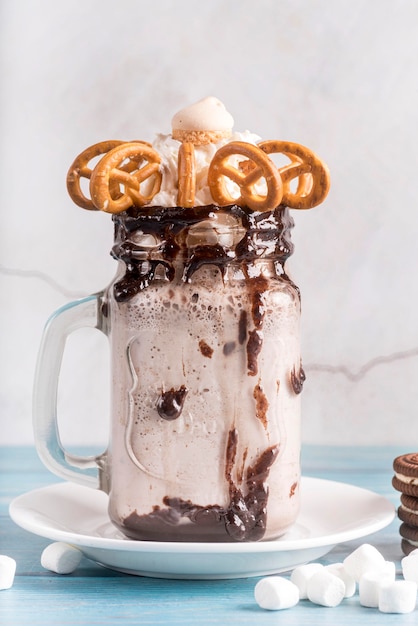 Front view of dessert in jar with pretzels and popcorn