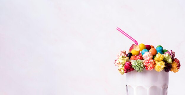 Front view of dessert with colorful topping and straw