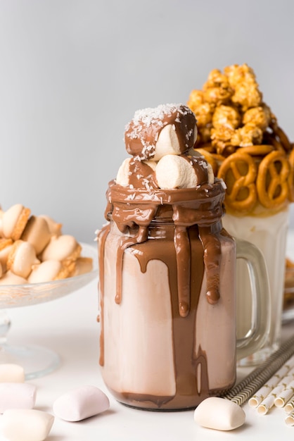 Front view of desserts with marshmallows and pretzels