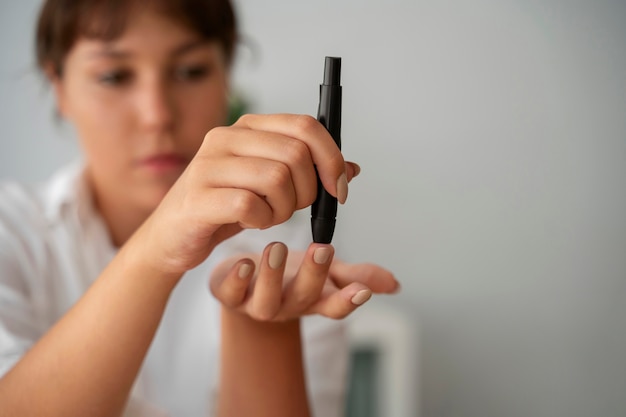 Front view diabetic woman checking her glucose level