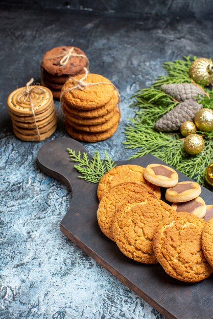 Front view different delicious biscuits on light-dark surface