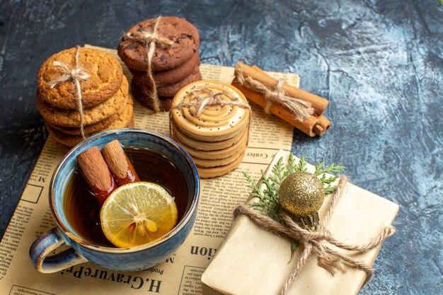 Front view different delicious biscuits with cup of tea on light background