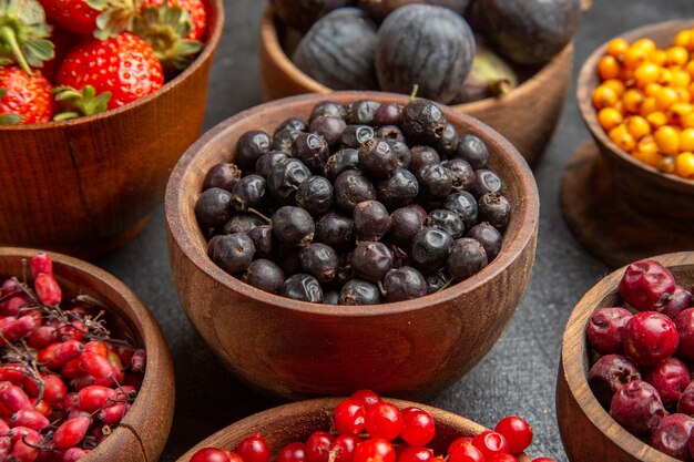 Front view different fresh fruits inside plates on dark background fruits color photo many mellow juice