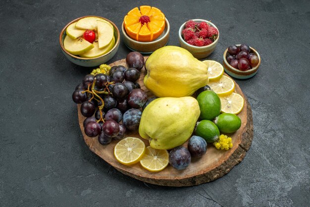 Front view different fruits composition fresh and ripe on dark-grey background ripe mellow fruits health plant color