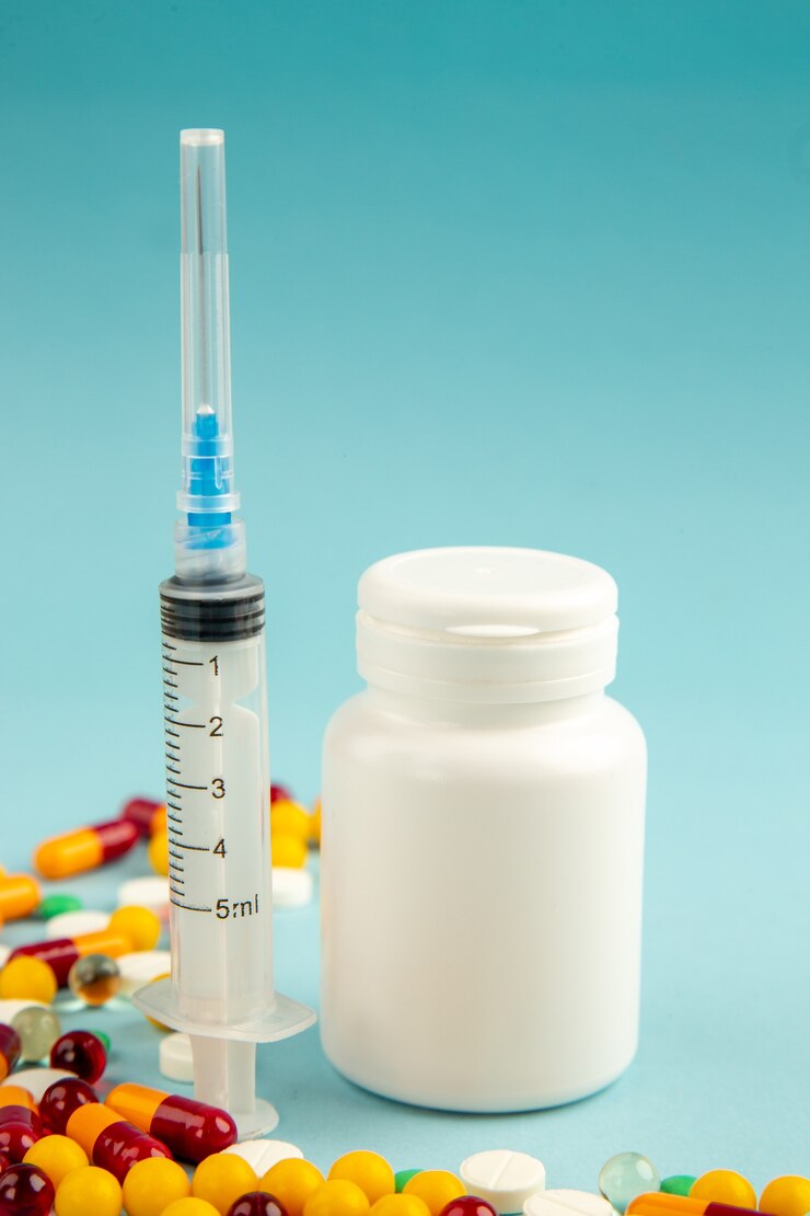 Free Photo front view different pills with vaccine and injection on blue surface virus lab health covid hospital pandemic color science drug