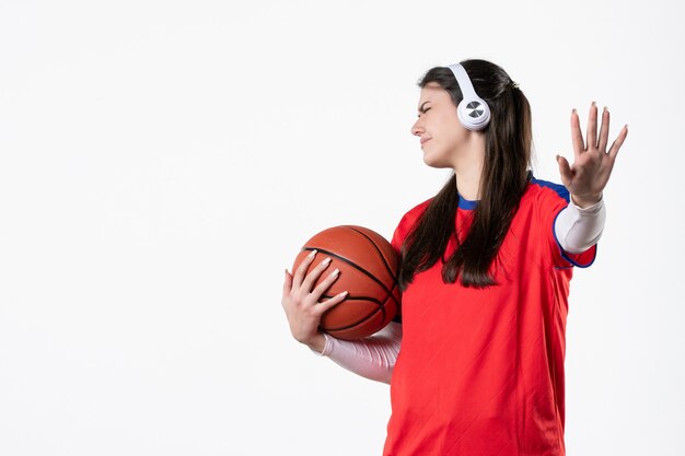 Front view displeased young female in sport clothes with basketball