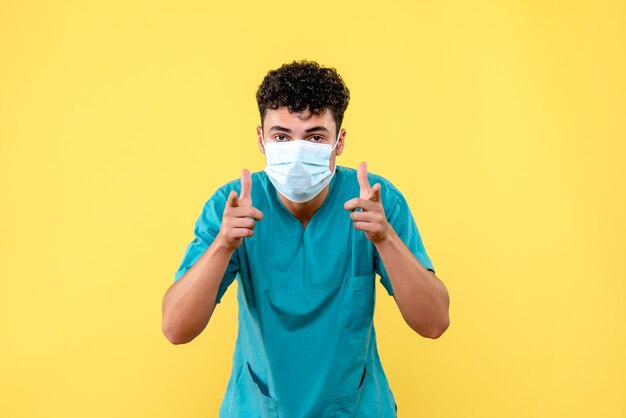 Front view doctor the doctor in mask is talking about hygiene rules