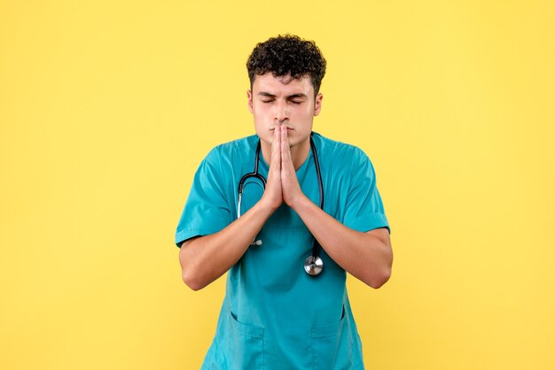 Front view doctor the doctor prays for patients with serious disease