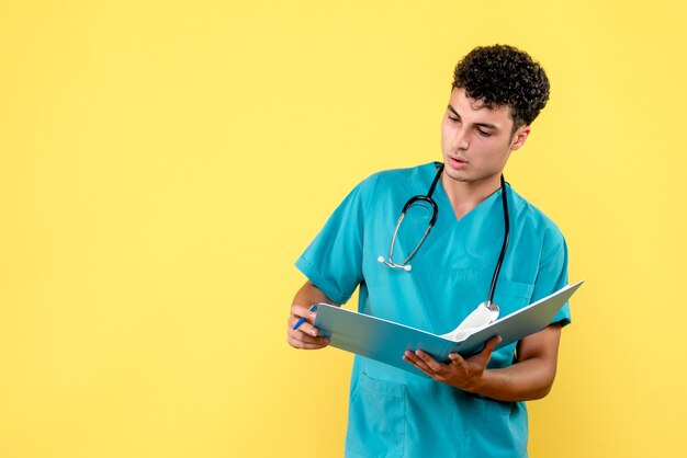 Front view doctor the doctor with blue folder is analizing the results of patient