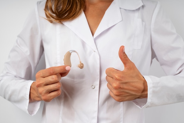 front-view-doctor-holding-hearing-aids_23-2149706001.jpg