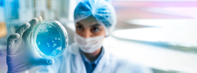 Front view doctor holding petri dish