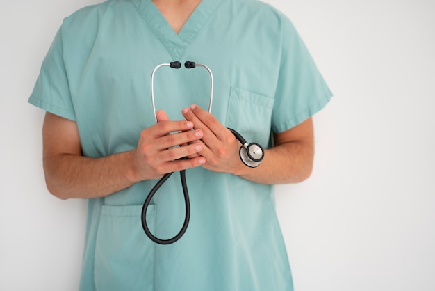 Front view doctor holding stethoscope