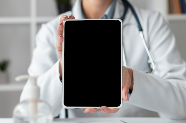 Front view doctor holding tablet