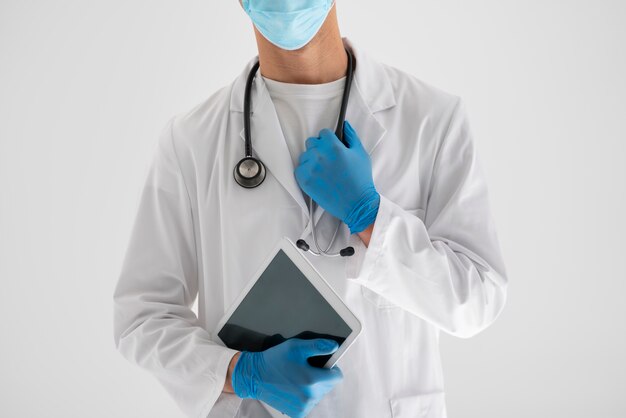 Front view doctor holding tablet