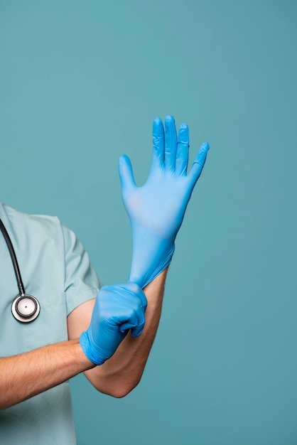 Front view doctor putting on glove