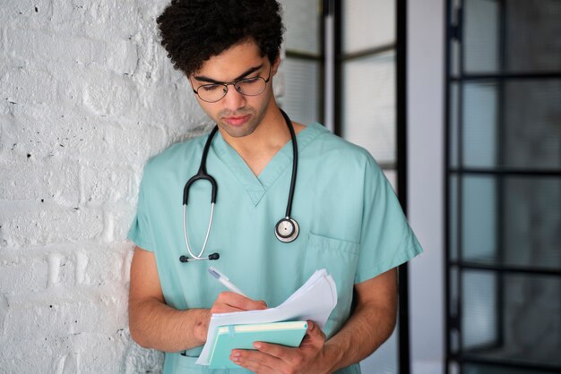 Free photo front view doctor taking notes