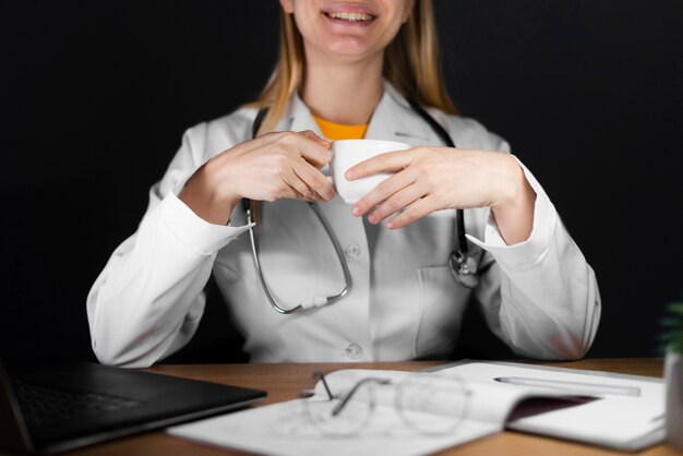 Front view of doctor with coffee