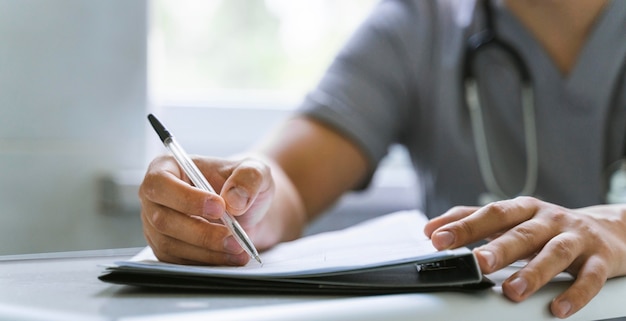 Front view of doctor writing a prescription