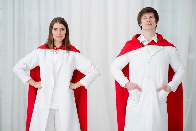 Front view doctors posing with capes