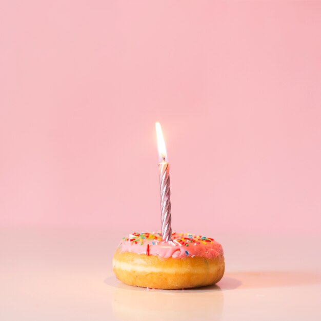 Front view donut with lit candle