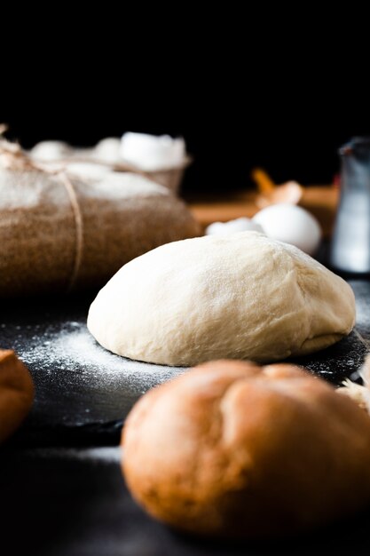 Front view of dough and bread on table