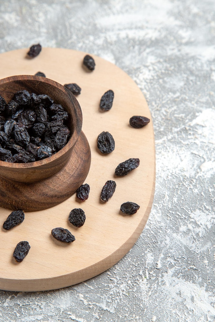 Free Photo front view dried black raisins on a white space