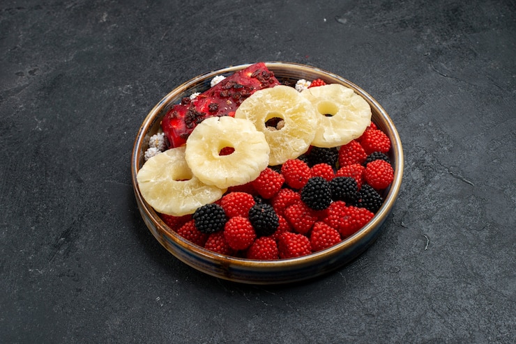 Free Photo front view dried pineapple rings with confiture berries on dark-grey surface fruit dry raisin sweet sugar candy photo