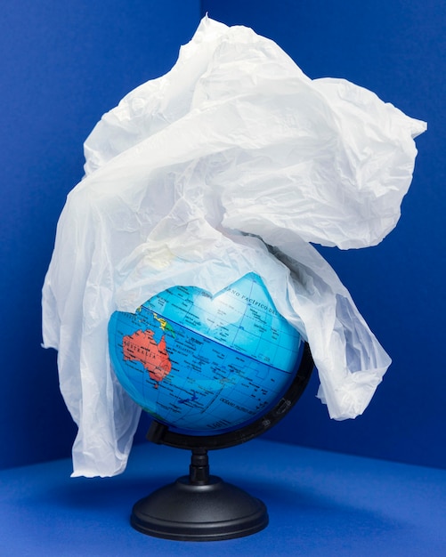 Front view of earth globe covered in plastic