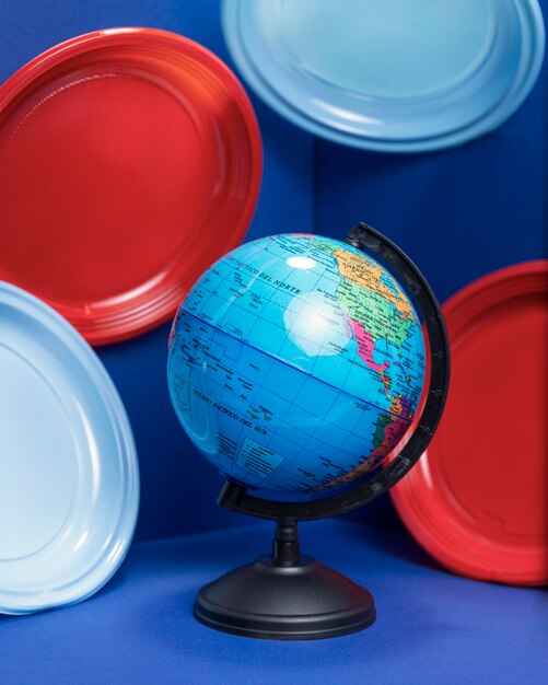 Front view of earth globe with plastic plates