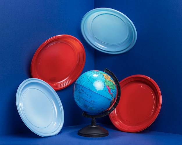 Front view of earth globe with plastic plates