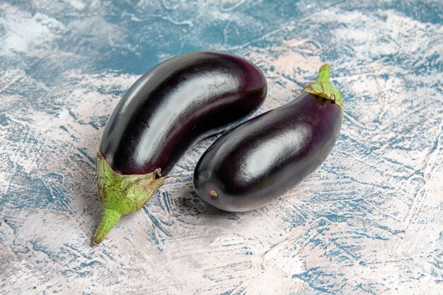 Front view eggplants on blue-white background with copy space