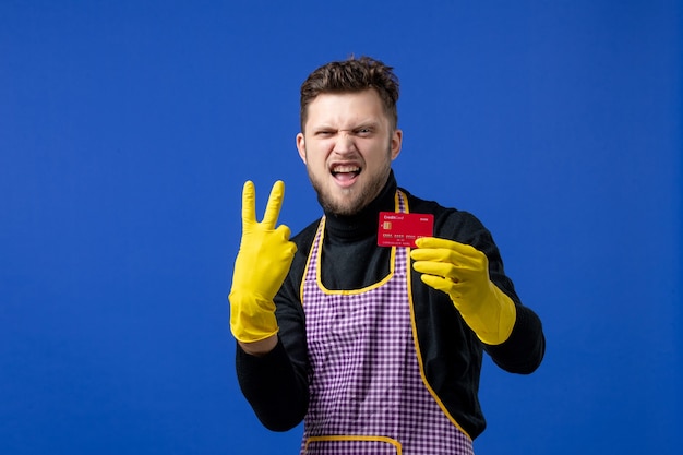 Front view elated young man making victory sign on blue space