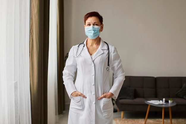 Front view of elder covid recovery center female doctor with medical mask