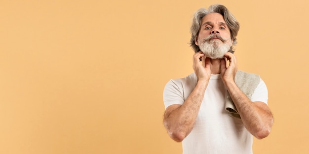 Front view of elder man with beard and copy space